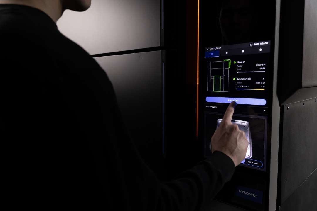 Formlabs Fuse X1 touchscreen showing live print status: Nylon 12 hopper level, build chamber temperature, and internal camera feed