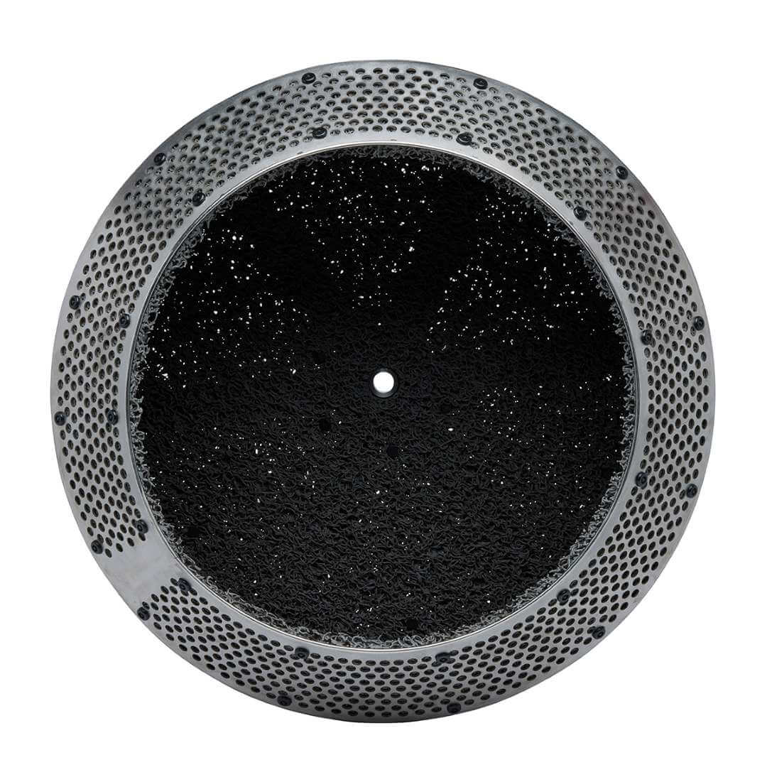 Top-down view of the Formlabs Fuse Blast High Capacity Kit large tumbler basket showing the circular perforated stainless steel rim and black rubber liner interior with central mounting pin