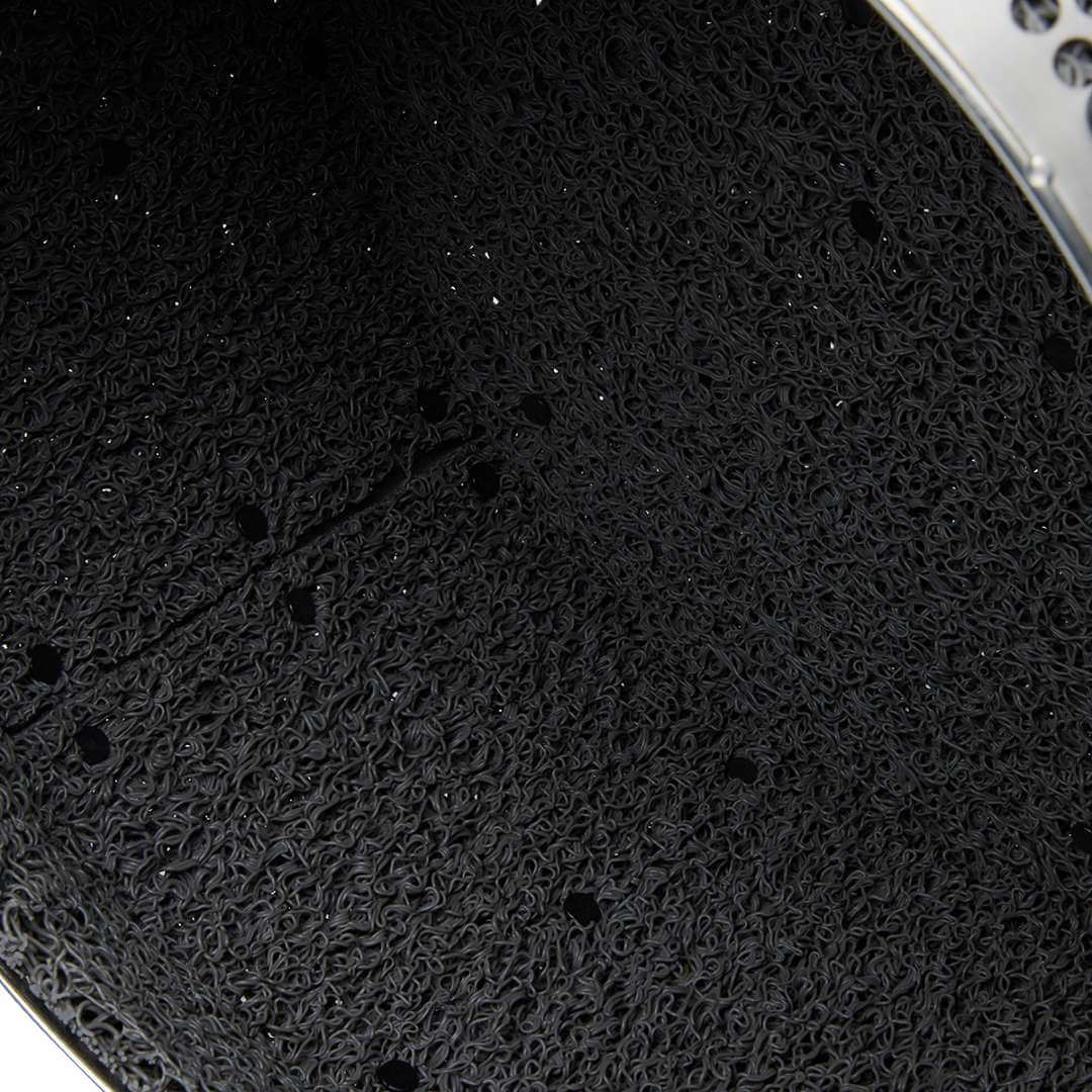 Macro close-up of the black rubber liner interior surface of the Fuse Blast High Capacity Kit large tumbler basket showing the dense interlocking coil texture that cushions parts during blasting