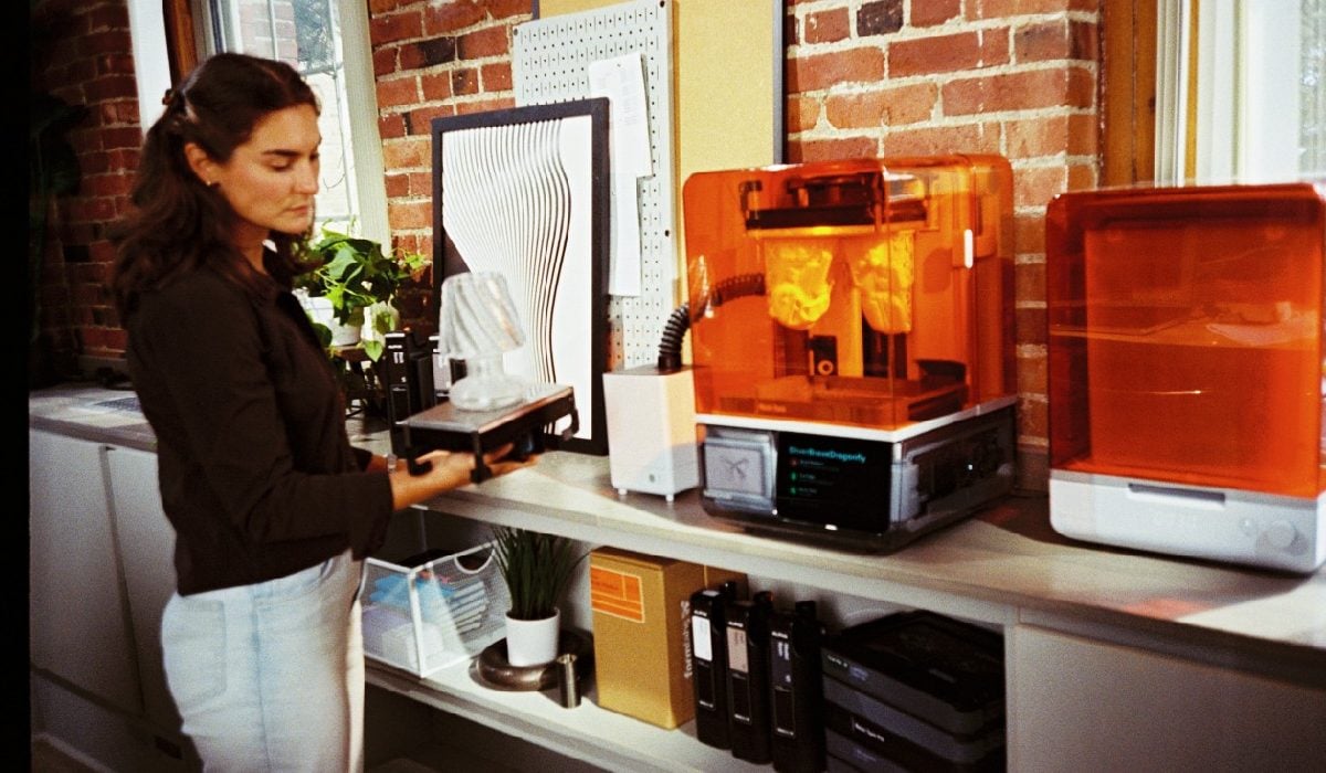 Compact Formlabs VOC Extractor module next to a photopolymer 3D printer in a workspace