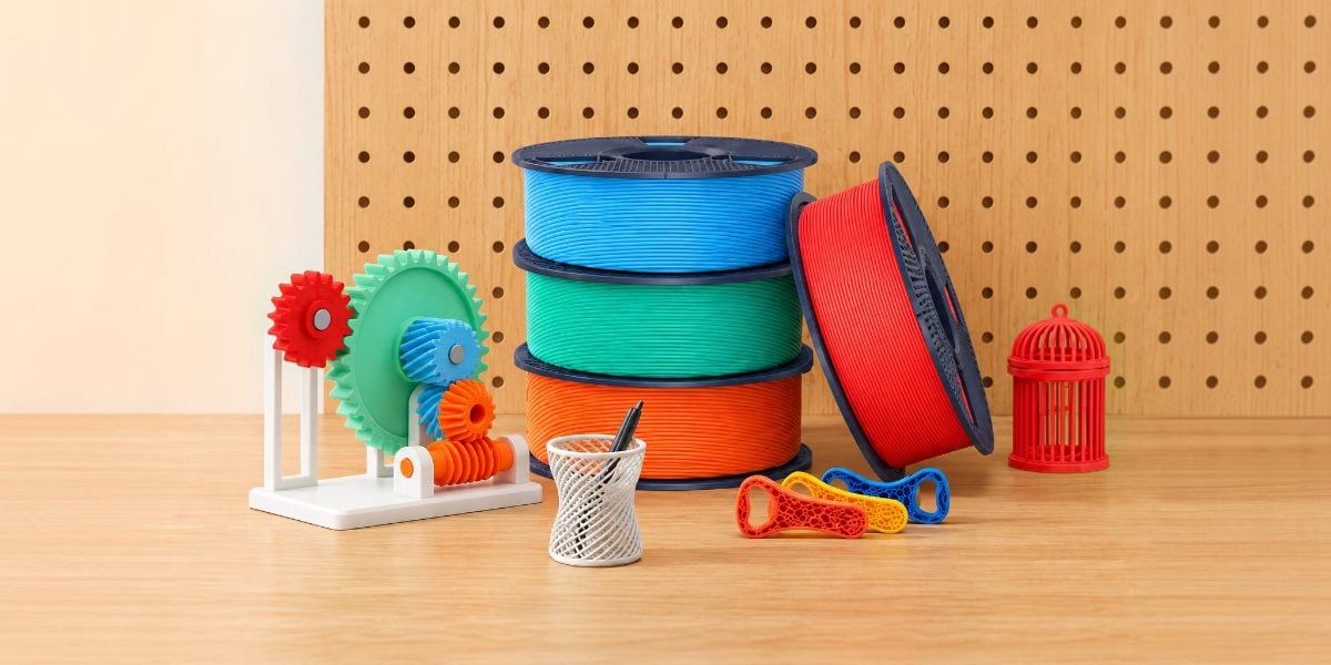 Spools of matte filament and samples of 3D-printed items.