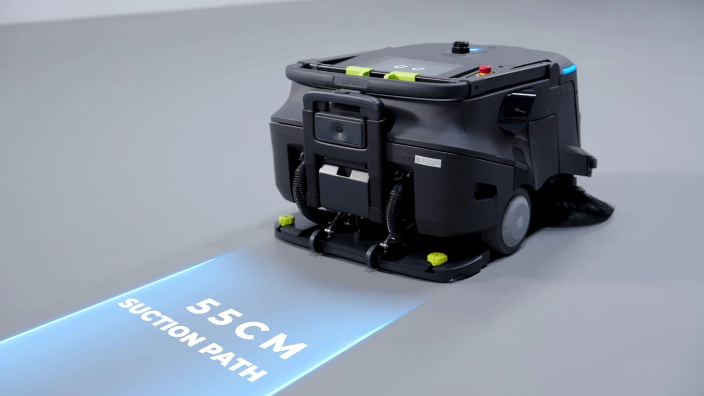 The PUDU MT1 VAC robot vacuum projects a lit suction path on the floor ahead
