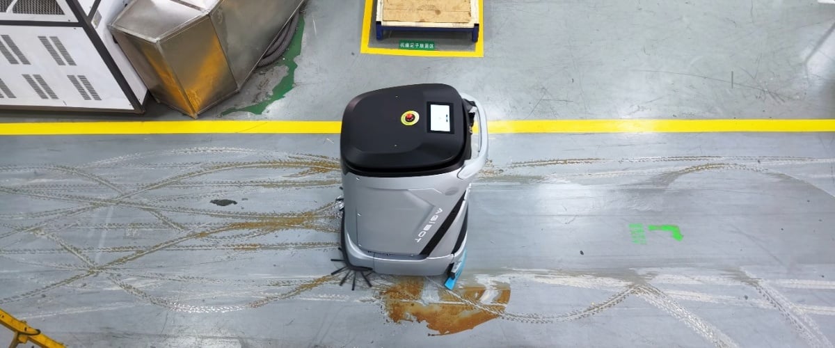 AgiBot C5 during cleaning of a dirty industrial floor